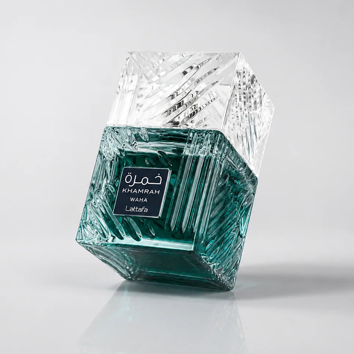 Decorative glass container with geometric design on a gray background