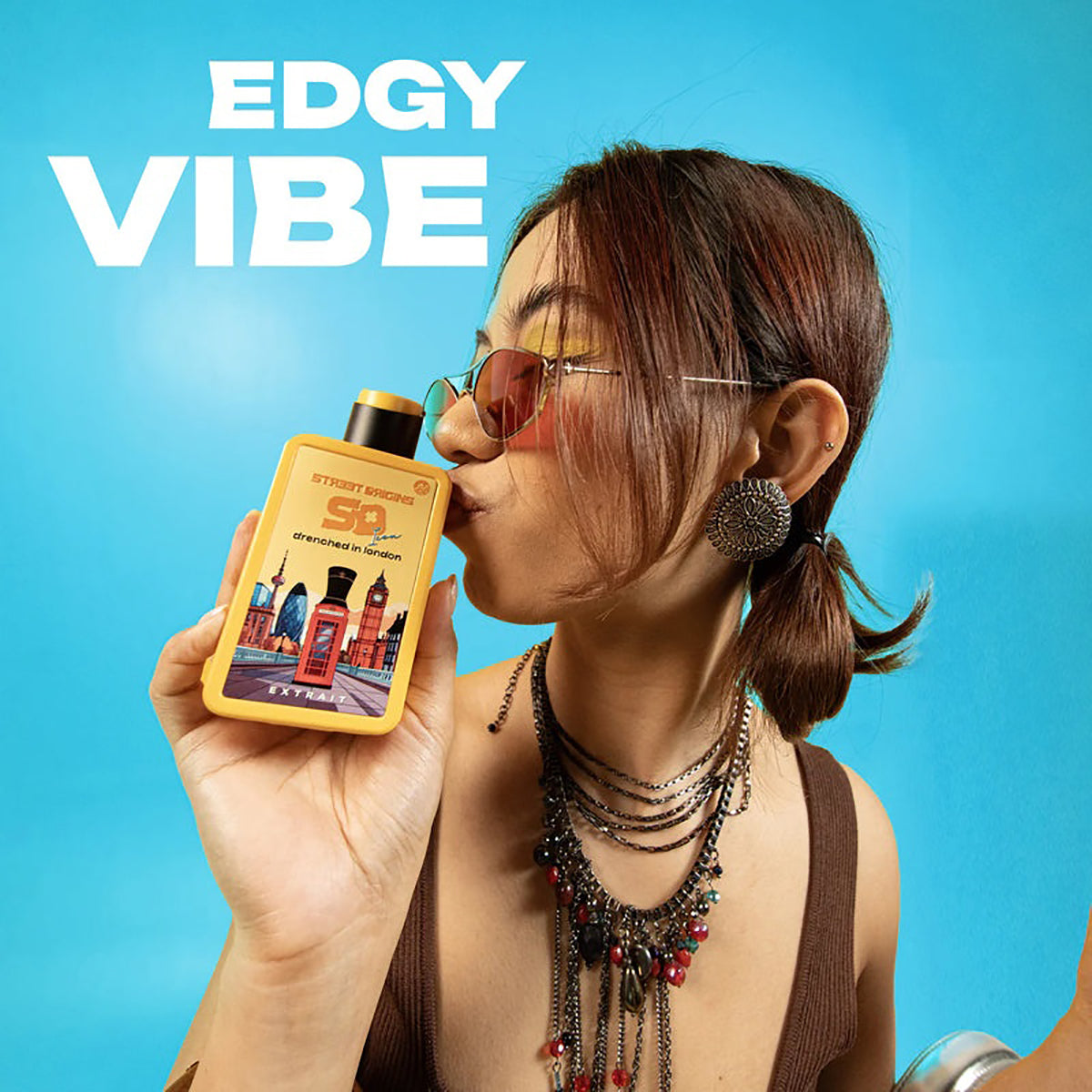 Person holding a colorful bottle with 'EDGY VIBE' text on a blue background